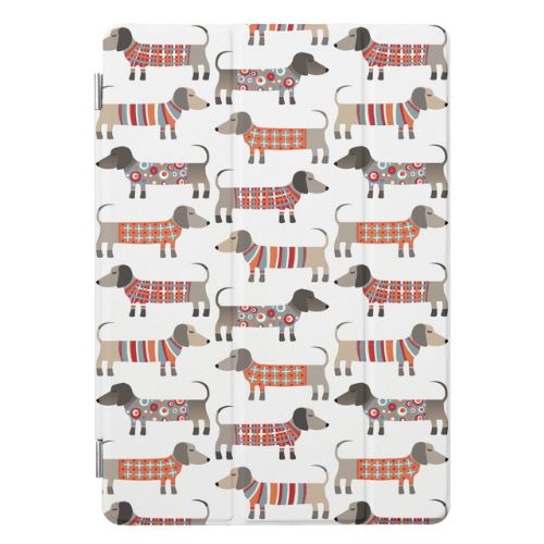 Cute iPad case with pattern design of dachshund sausage dogs wearing geometrical patterned dog coats.